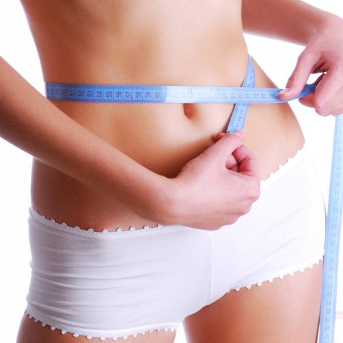 Woman measuring beauty slim waist. Health eating concept